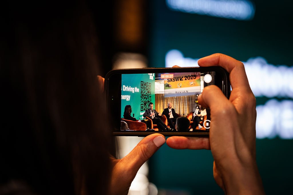 screen of a phone taking a picture of a panel discussion