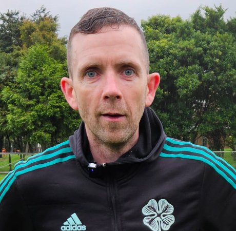 Image of Damien Brennan looking at the camera while stood on the pitch.