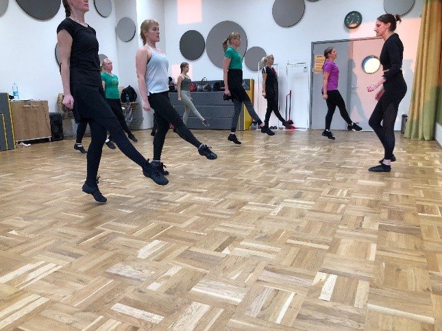 Group of women Irish dancing in a hall