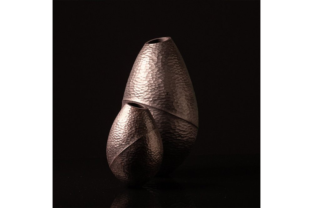 Two wooden vases that have been bleached and ebonised to change the texture of the wood.