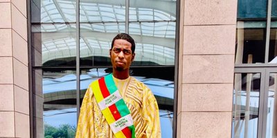 Ousmanou Abdou, pictured at the Sightsavers Cameroon country office, after his election, holding his walking stick.