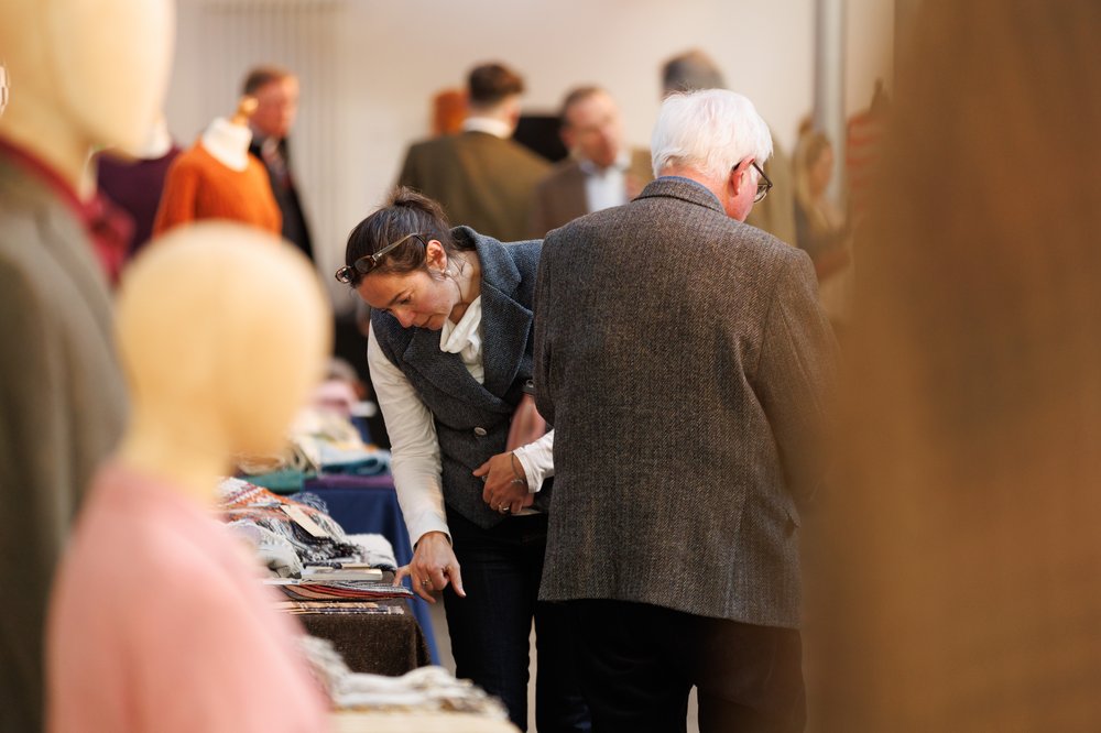 People looking at a stand and pointing