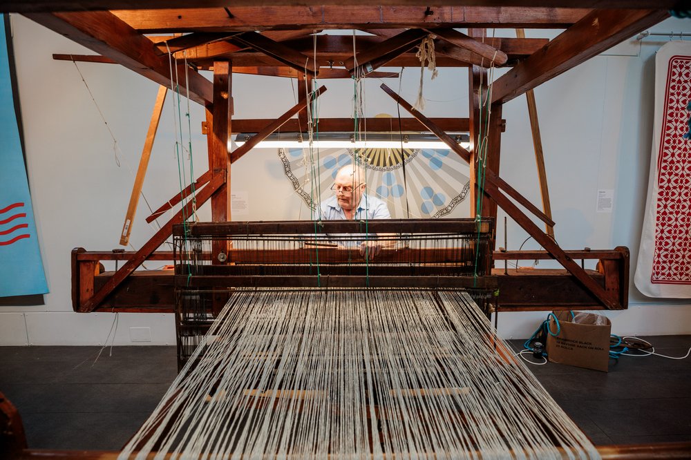 Man weaving with machine