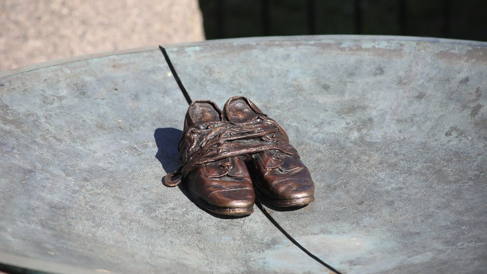 Bronze sculpture of children's shoes from the Irish Famine