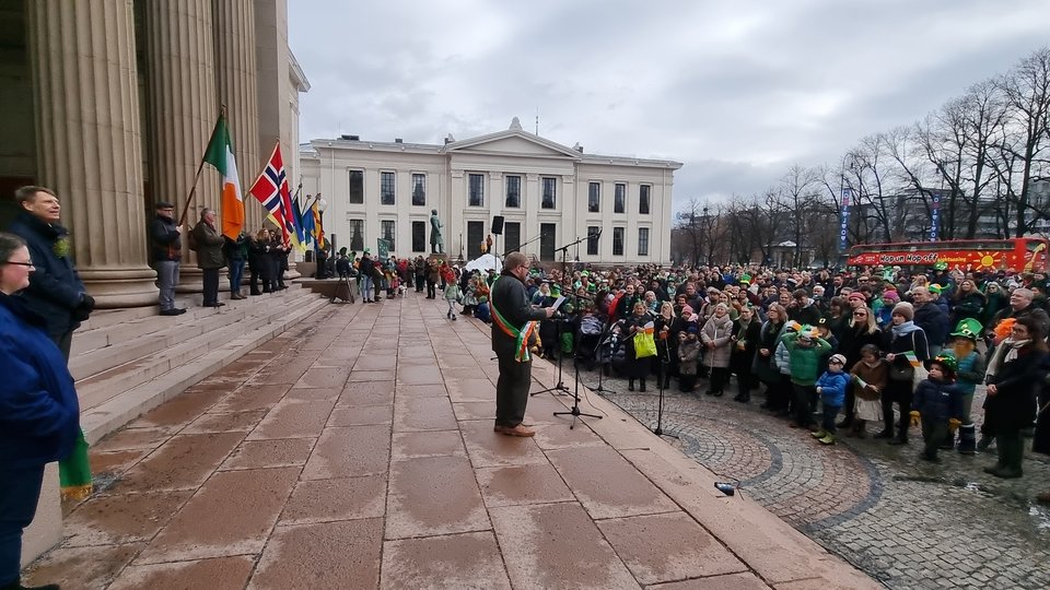 A man presenting to a large crowd