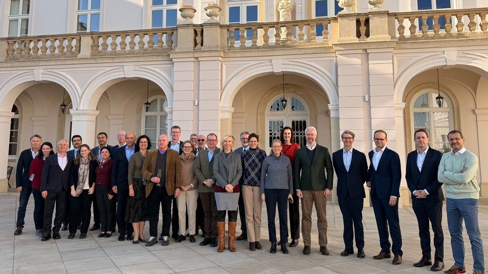A group picture of all the Irish EU heads of missions outside a building