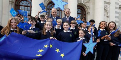 class of school kids with ministers and EU flags