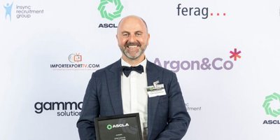 Man standing with an award