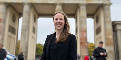 woman standing in front of the Brandenburg Gate