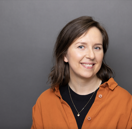 Woman in an orange shirt smiling