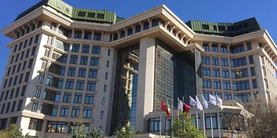 The Embassy building in Ankara with flags flying outside.