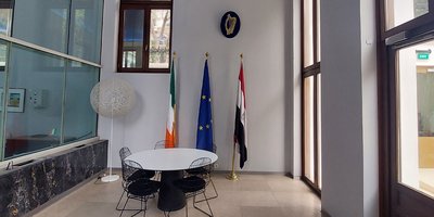 View of entryway of Embassy office with Irish, EU and Egypt flags.