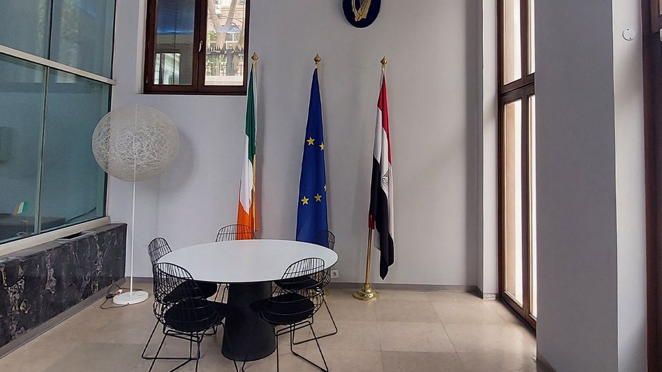 Lobby of the Embassy's office with Irish, EU and Egyptian flags displayed.