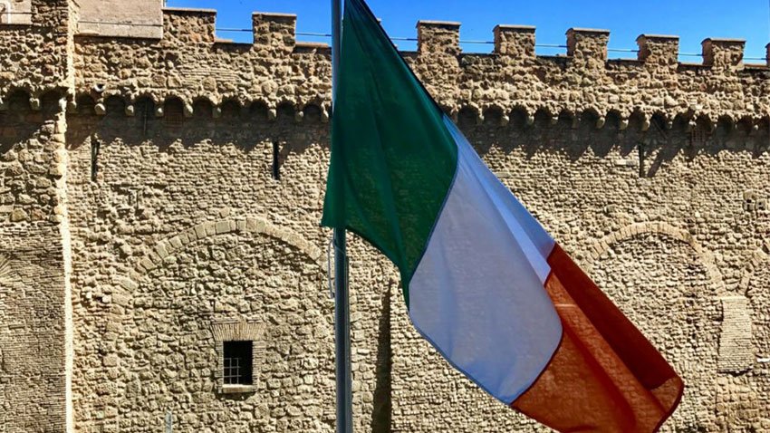 Irish flag flying in front of the walls of the Vatican.