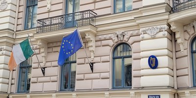 Front of the Irish Embassy in Latvia with Irish and European flags flying outside.
