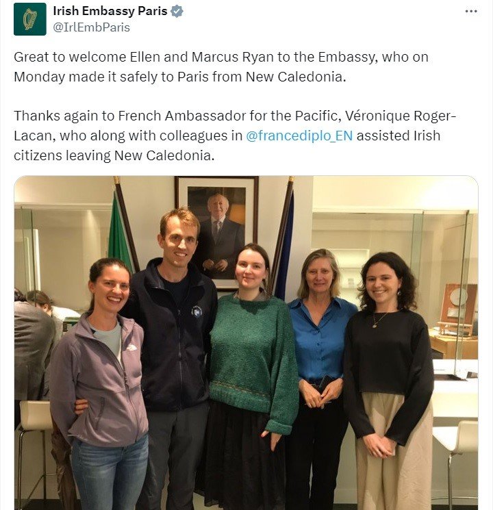 A tweet from the Irish Embassy in Paris with a photo of Irish citizens and Embassy staff with text celebrating their arrival in Paris from New Caledonia.