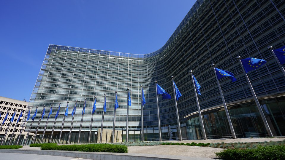 EU flags against the backdrop of the European Commission in Brussels
