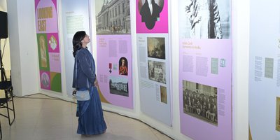 A woman viewing exhibition panels