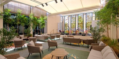 The Courtyard, a gathering space within the Irish Pavilion at Expo, featuring multiple breakout spaces for people to sit and meet.