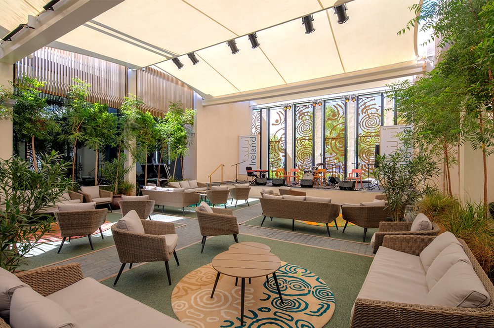The Courtyard, a gathering space within the Irish Pavilion at Expo, featuring multiple breakout spaces for people to sit and meet.