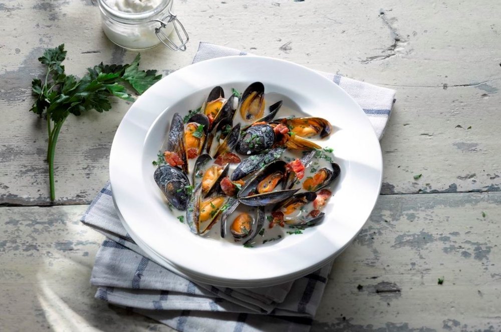 bowl of mussels on a rustic table