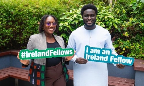 Two Senegalese fellows holding signs
