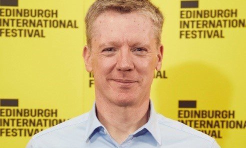fergus Linehan standing in front of a yellow background