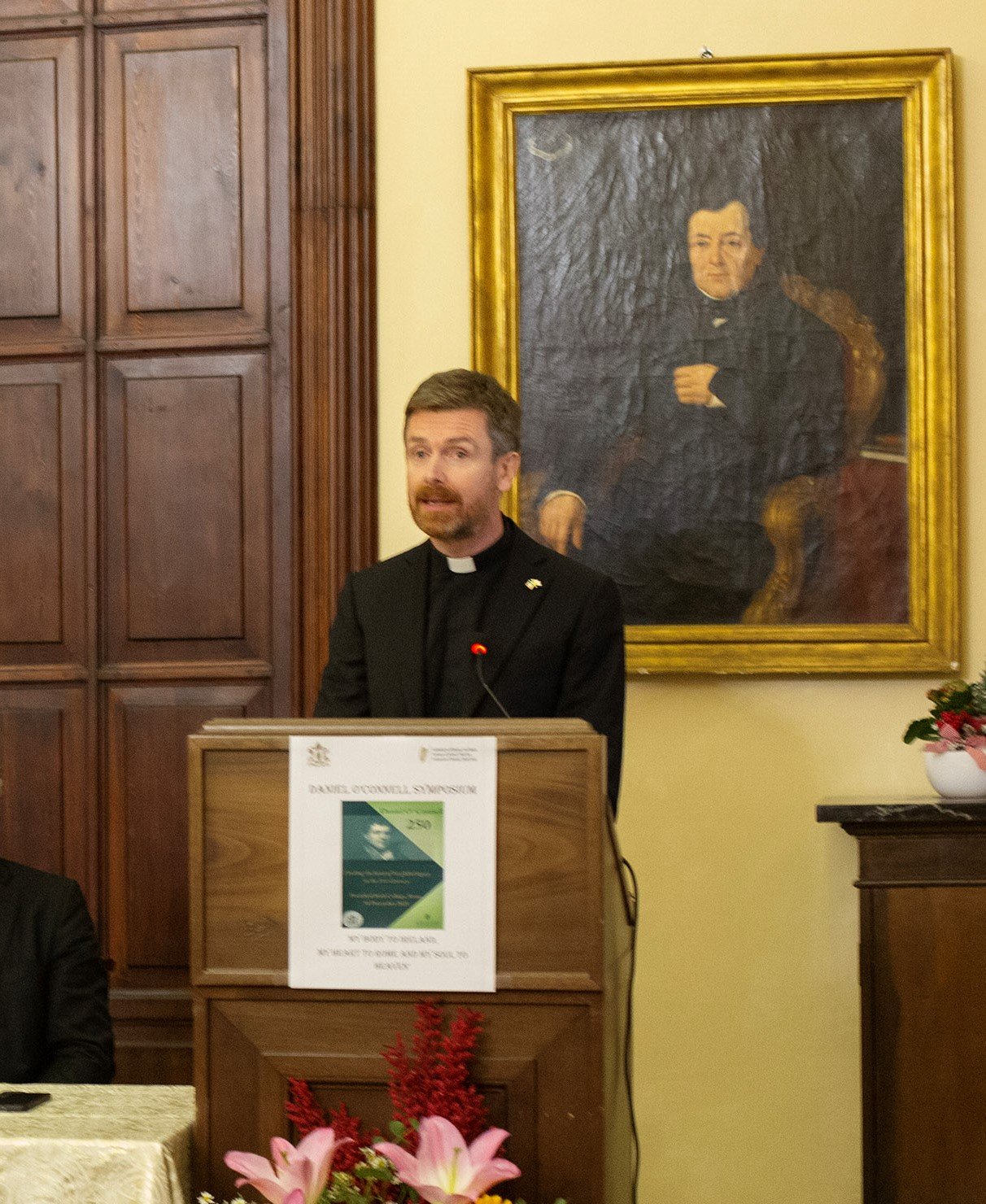 Man speaking at a plinth