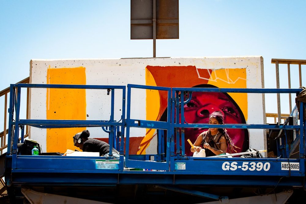 Artist painting on a wall