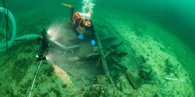 Man diving by a ship wreck