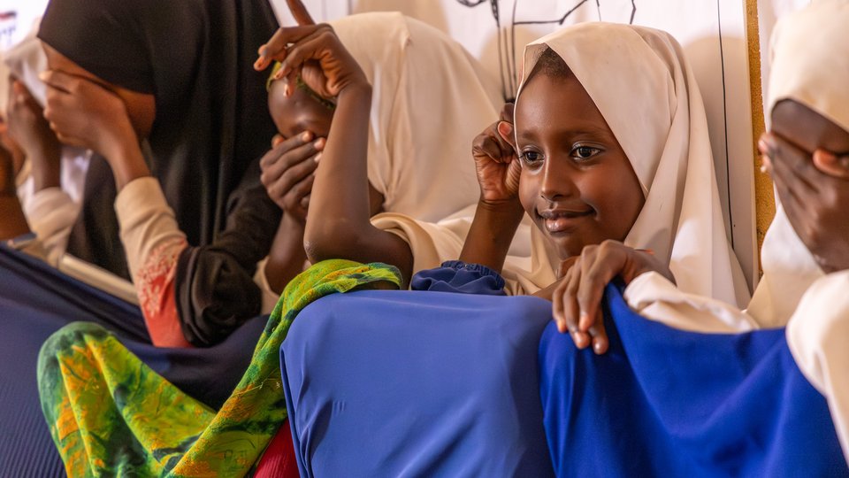 Amina, Sarah and Fartun taking part in the title selection for their story at the reading club in Diilin Primary School, Nugal region, Puntland State, Somalia.