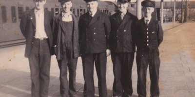 Workmen posed together at a trainstation