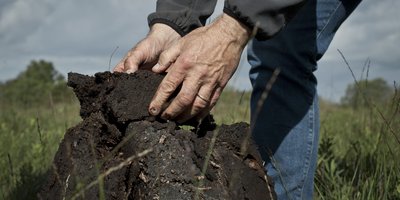 Man laying turf down in block
