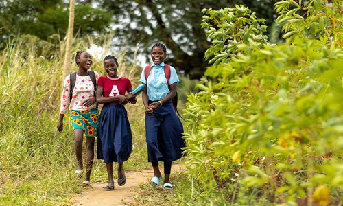 Three girls walking to school in Mozambique.