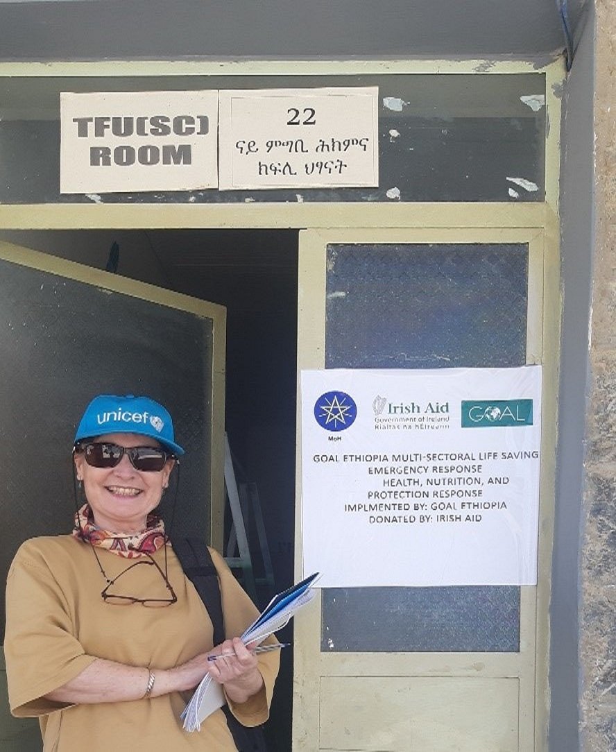Grace outside an emergency response room in Ethiopia wearing a hat