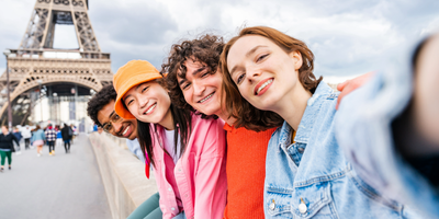 Four friends taking a selfie at the Eiffel Tower