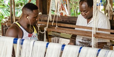Two men working on a loom