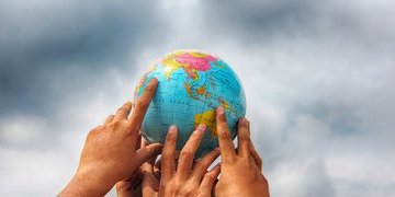 Hands on a globe