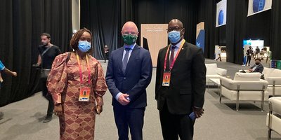 one woman and two men wearing masks