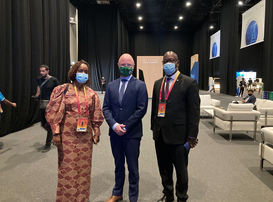 one woman and two men wearing masks