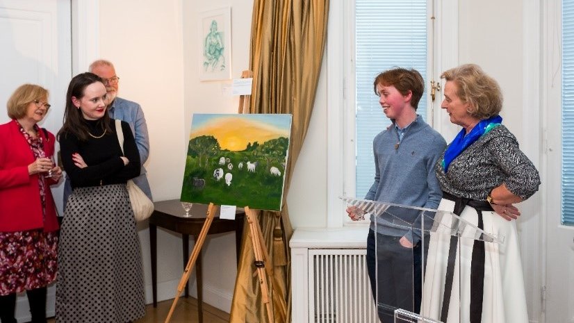 People looking at a painting in an exhibition in the Irish Embassy in Sweden