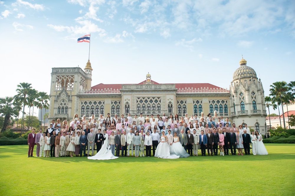 A group of LGBTQ+ couples in wedding attire