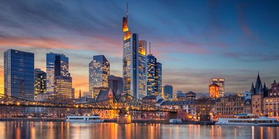 Frankfurt city skyline, with skyscrapers lit up.