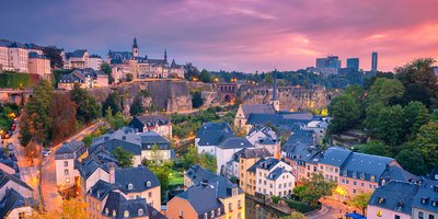 Luxembourg city at dusk with a pink cloudy sky