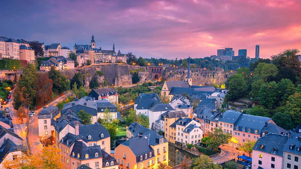 Skyline of Luxembourg at sunset with pink-hued skies
