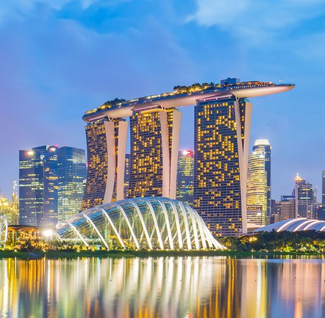 Singapore's skyline lit up at dusk.