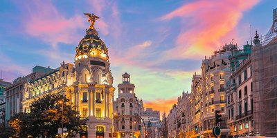 View of the Grand Via main street in Madrid at sunset.