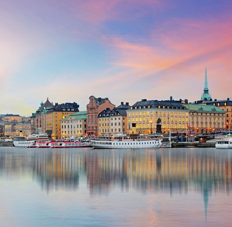 View of Stockholm's skyline across the water at sunset.