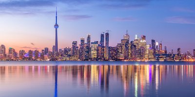 View of Toronto's skyline from the water at sunrise.