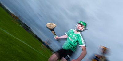 A boy playing hurling